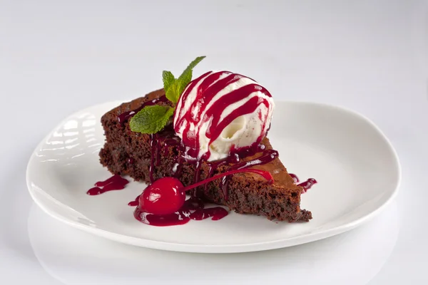 Chocolate cake with ice cream and cherry jam — Stock Photo, Image