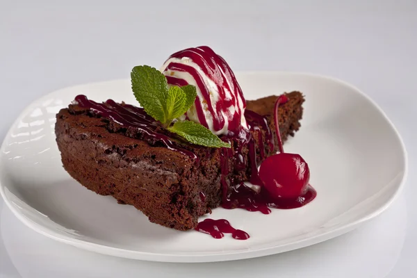 Chocolate cake with ice cream and cherry jam — Stock Photo, Image