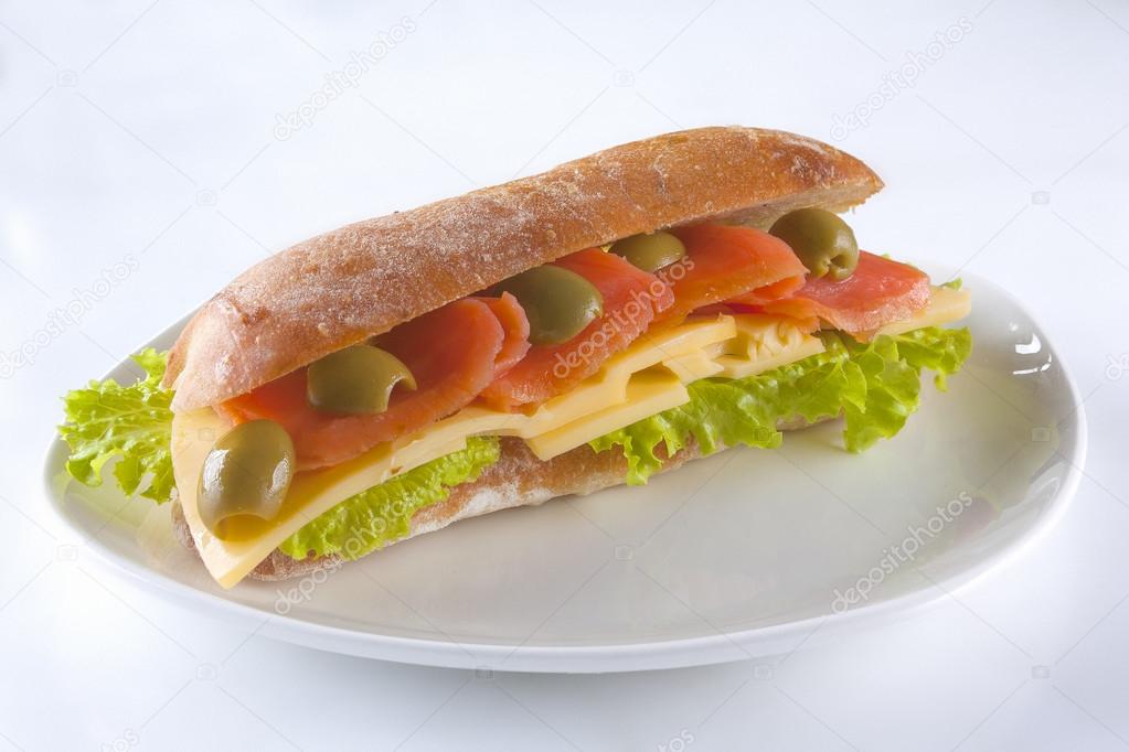 Foot long sandwich on a plate isolated on white background
