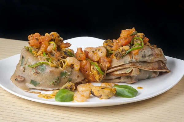 Pancakes with shrimp on black background — Stock Photo, Image