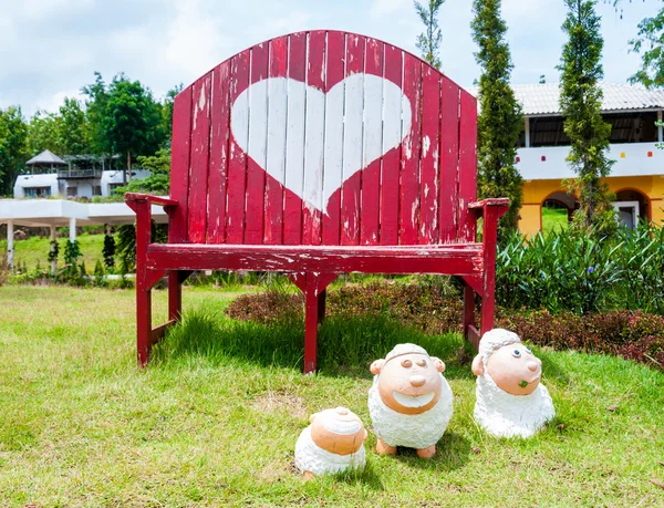 Kırmızı tezgah sandalye ile kalp simgesi ve koyun Heykel Bahçe
