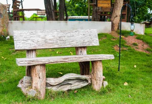 Wooden chair with lamp in the garden or park — Stock Photo, Image