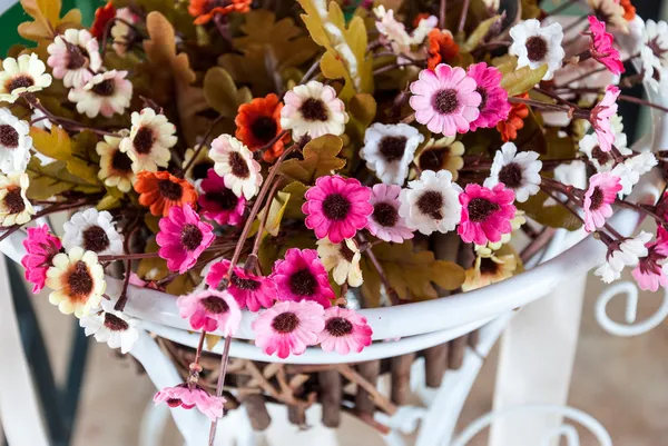 bir tencerede yapay plastik küçük çiçek güzel renkler