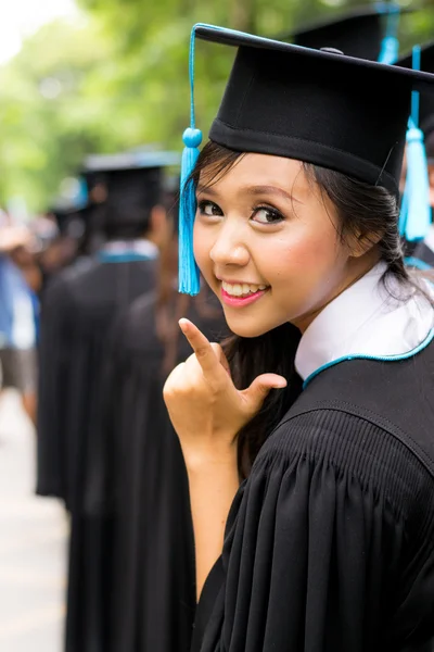 College degree. Happy young woman in robe Stock Photo