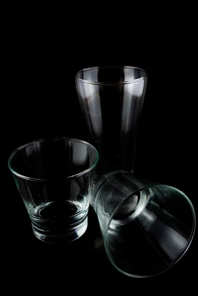 Vasos vacíos para whisky sobre una superficie reflectante sobre fondo negro — Foto de Stock