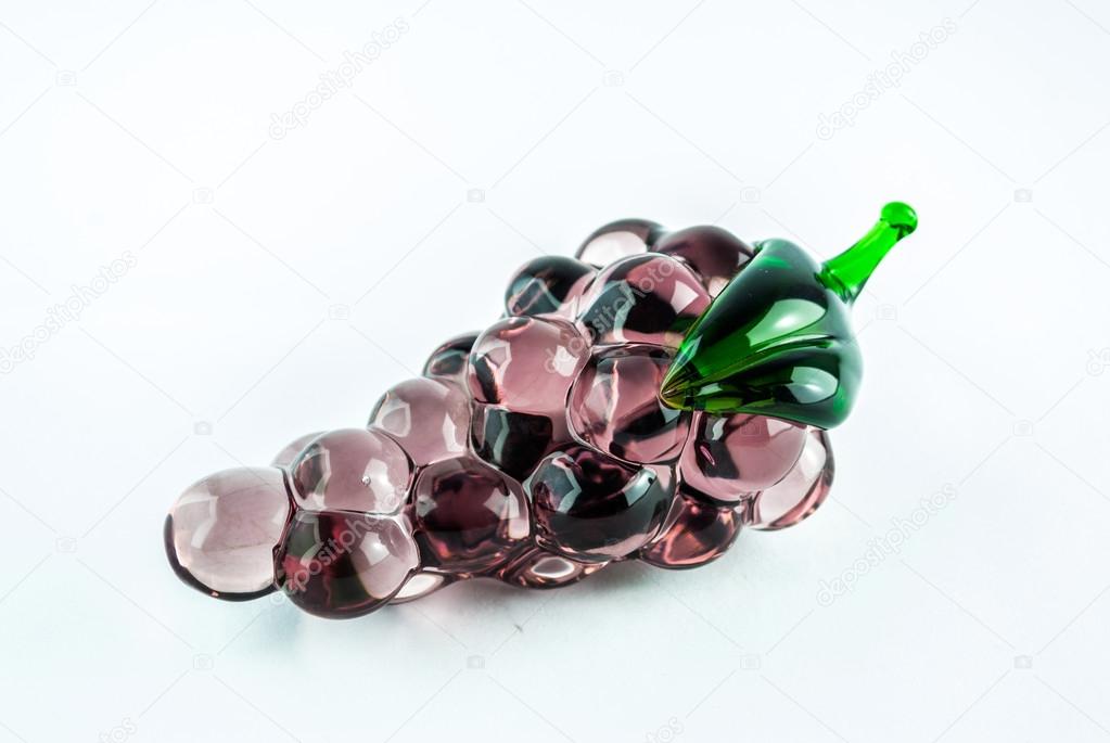 Gems arranged in the form of grapes on white background