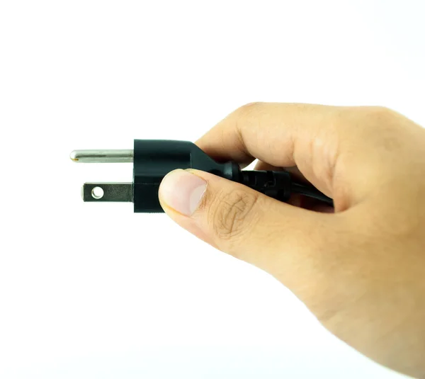 Enchufe eléctrico con la mano - enchufe de alimentación - Cable eléctrico negro aislado en blanco — Foto de Stock