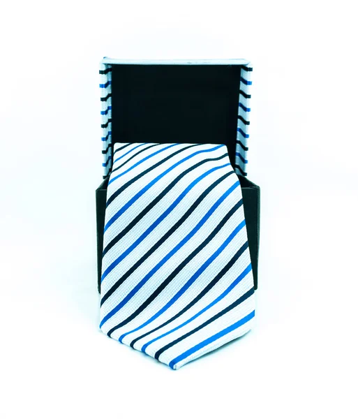 Scatola nera da cui pende una cravatta sfondo bianco, isolato - cravatta moderna in una scatola aperta — Foto Stock