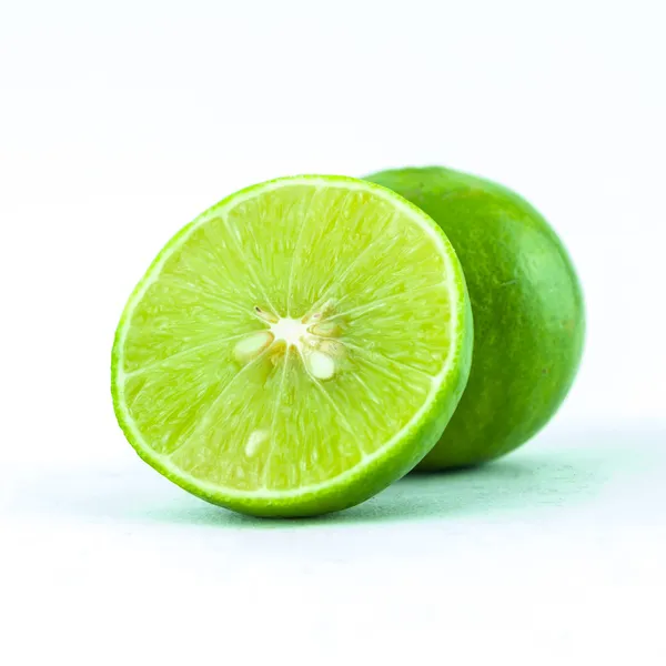 Green fresh lime and slice, Isolated on white background - Fresh limes Isolated on white Royalty Free Stock Photos