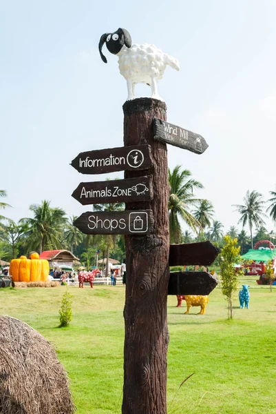 Wooden signage indicating a lot areas in zoo area. — Stock Photo, Image