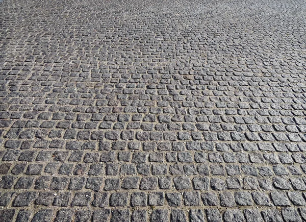 Vista de perto em uma estrada de paralelepípedos - padrão - fundo — Fotografia de Stock