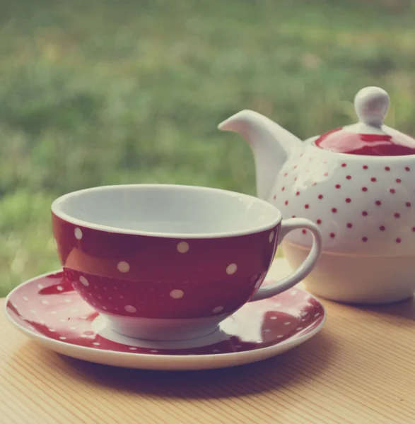 Red polka dot kettle and cup of tea retro — Stock Photo, Image