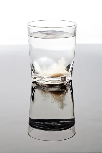 Effervescent tablet dissolved in a glass of water — Stock Photo, Image