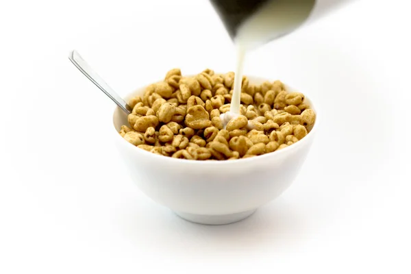 Wheat cereal in bowl with a spoon on white background — Stock Photo, Image