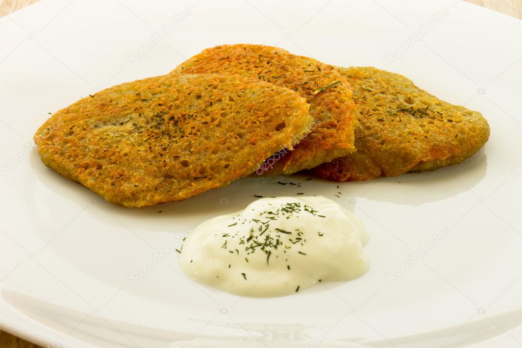 Homemade potato pancakes isolated on white plate
