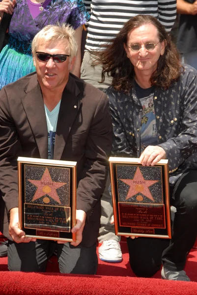 Alex Lifeson and Geddy Lee at the induction certain for RUSH into the Hollywood Walk of Fame, Hollywood, CA. 06-25-10 — стоковое фото