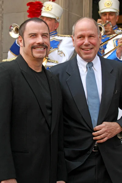 John Travolta and Michael D. Eisner — Stock Photo, Image