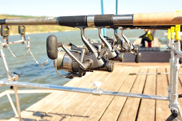 Reels with rods while fishing on a sunny day.