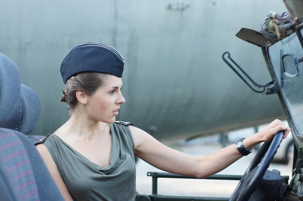 Young attractive female soldier driving the car — Stock Photo, Image