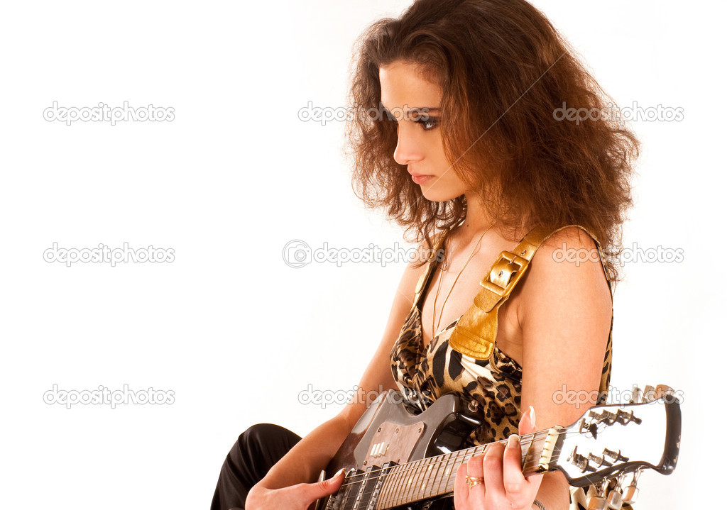 Attractive brunette playing the guitar