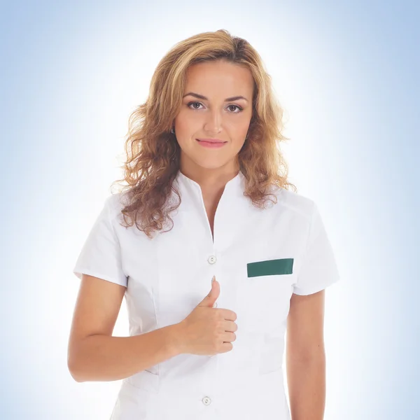 Young attractive female doctor isolated over blue background — Stock Photo, Image