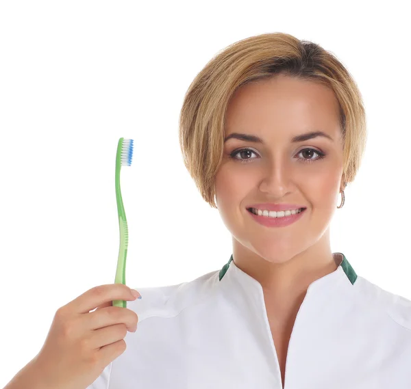 Young attractive dentist with a tooth brush isolated on white — Stock Photo, Image