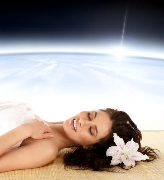 Woman in spa dreaming over abstract space background — Stock Photo, Image