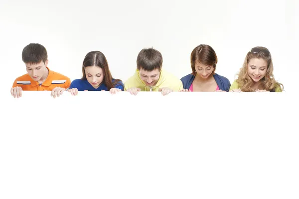 Group of teenagers with a giant, blank Royalty Free Stock Photos