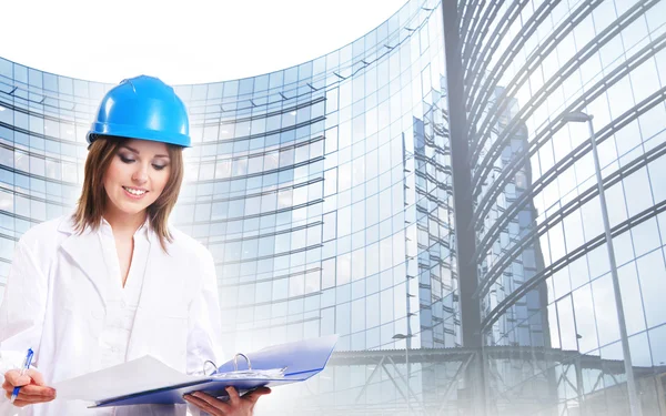 Young attractive female engineer over modern building — Stock Photo, Image