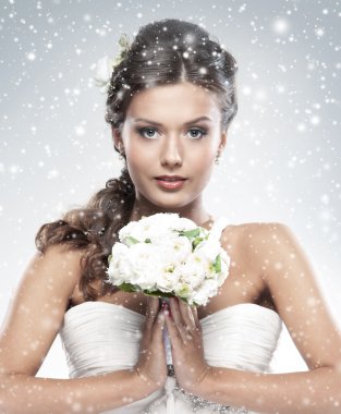 Young attractive bride with the bouquet of white roses clipart
