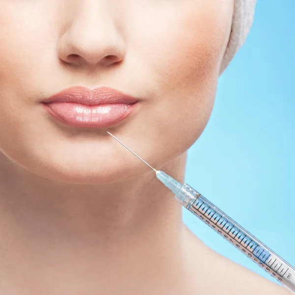 Mooie vrouw krijgt een injectie in haar gezicht — Stockfoto