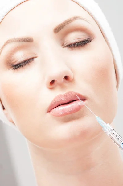 Beautiful woman gets an injection in her face — Stock Photo, Image