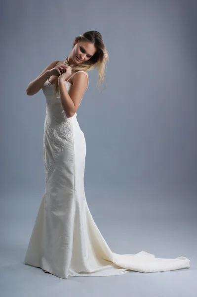 Young and sexy bride over grey background — Stock Photo, Image