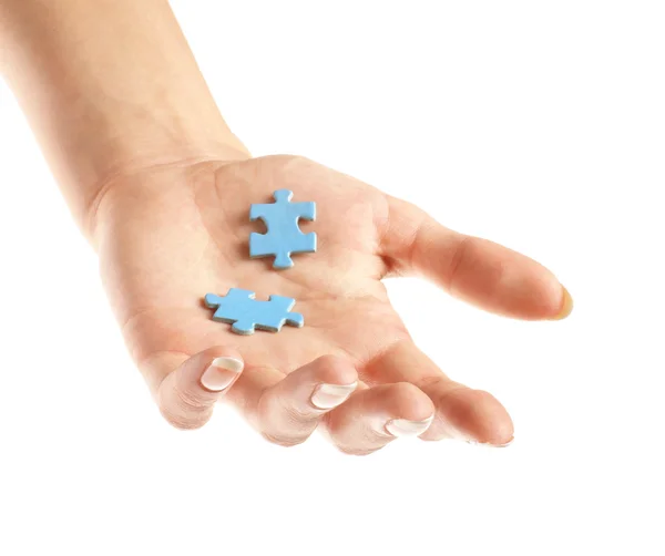 Two pieces of puzzle in hand — Stock Photo, Image