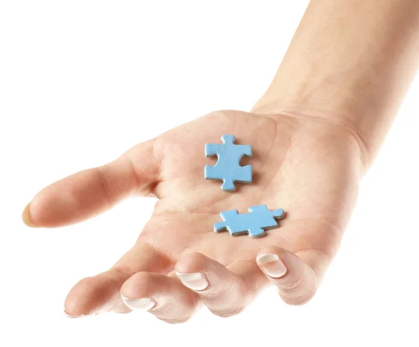Duas peças de quebra-cabeça na mão — Fotografia de Stock
