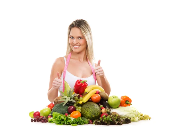 Jeune fille attrayante avec une pile de fruits et légumes — Photo