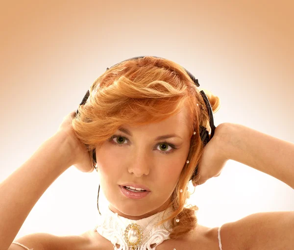 Sexy redhead listening to the music — Stock Photo, Image