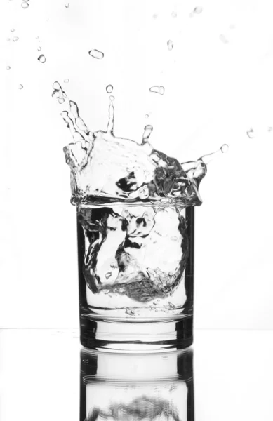 Beautiful splash of ice in the glass — Stock Photo, Image