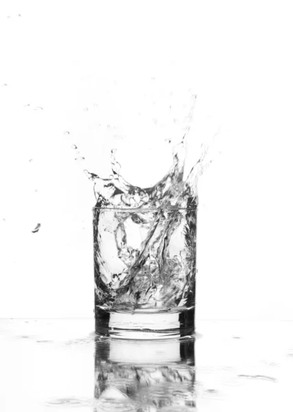 Beautiful splash of ice in the glass — Stock Photo, Image