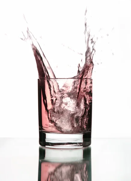 Beautiful splash of ice in the glass — Stock Photo, Image