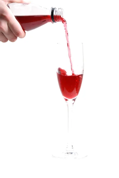 Red liquid pouring into the glass — Stock Photo, Image