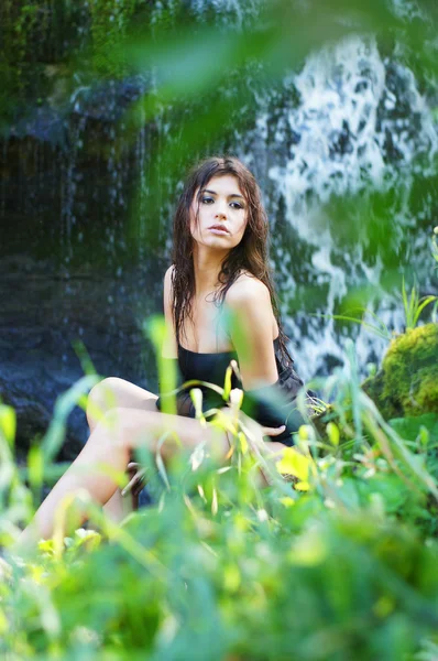 Menina jovem e bonita de biquíni tomando banho em uma cachoeira — Fotografia de Stock