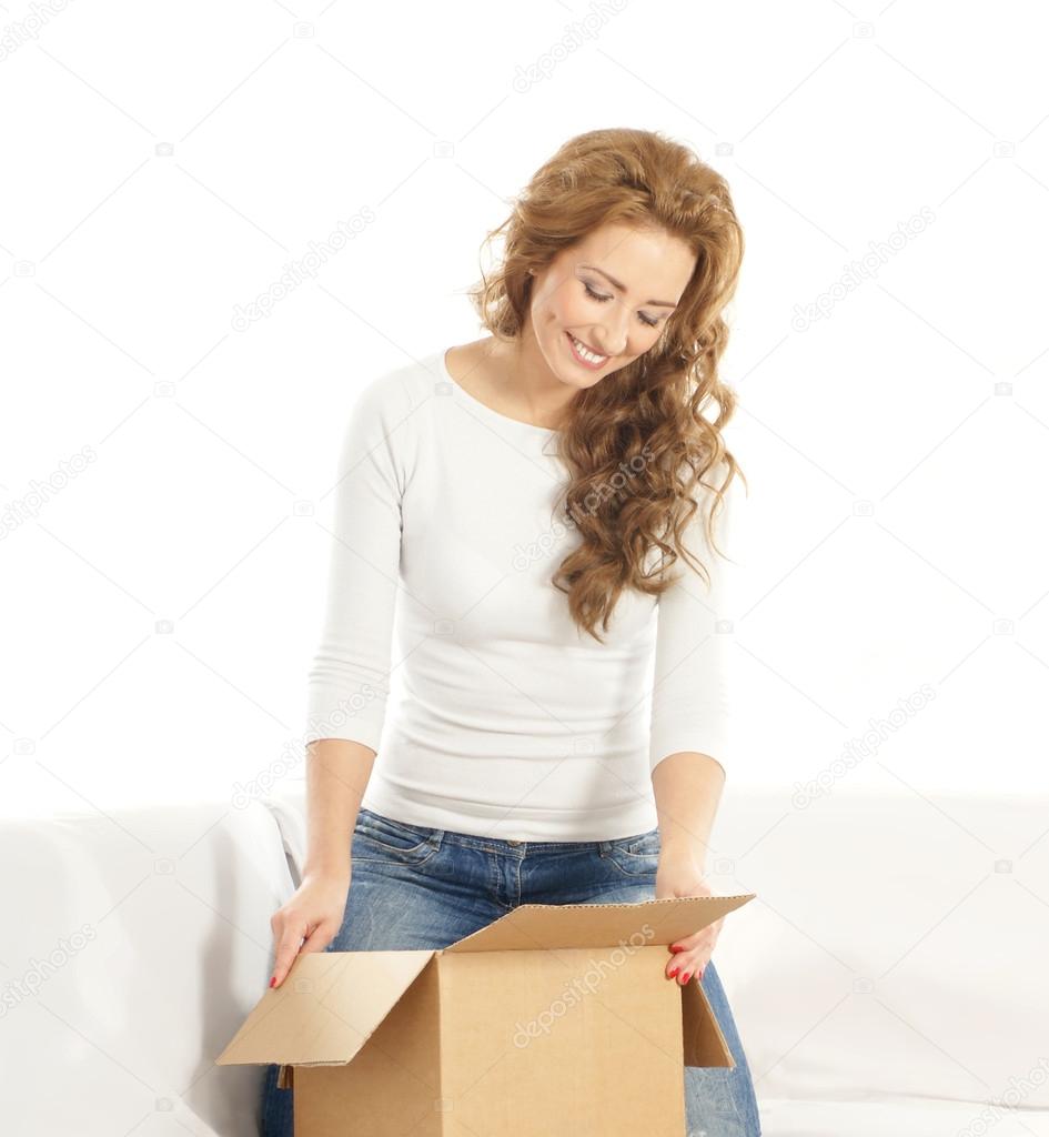Young attractive woman with a parcel in modern interior