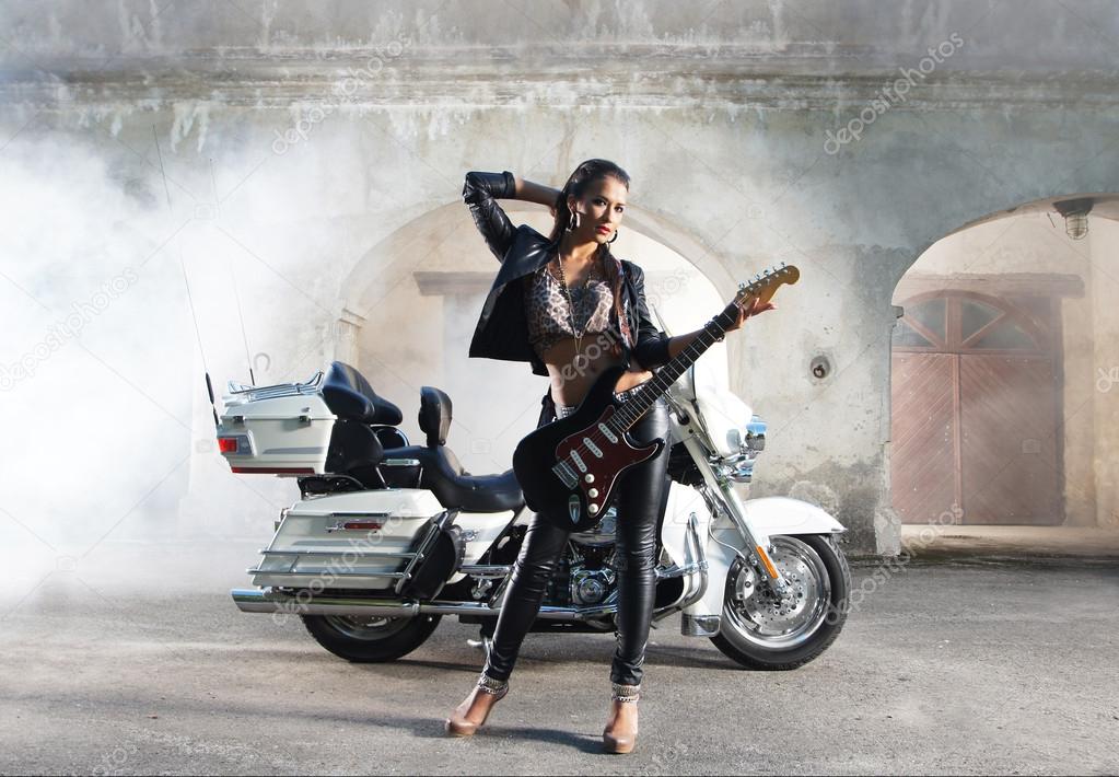 Sexy female biker with a guitar