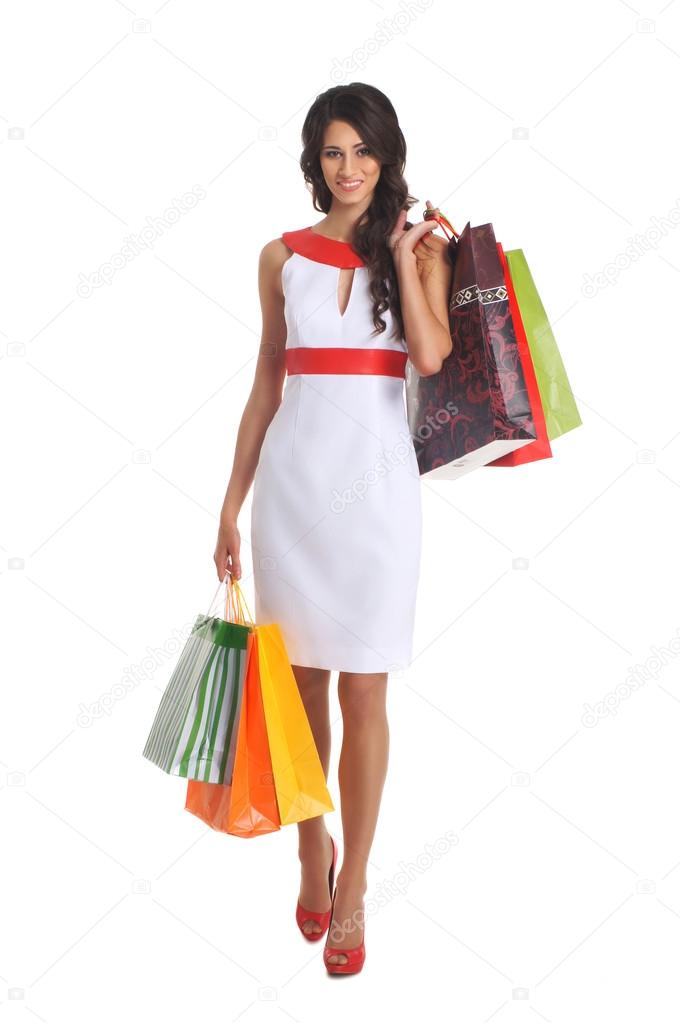 Young beautiful woman with some shopping bags isolated on white