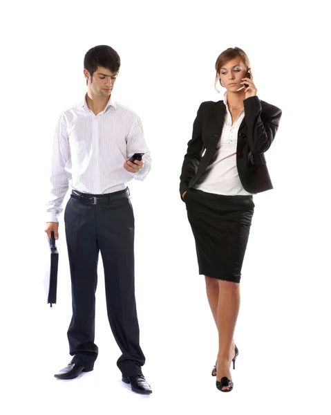 Casal jovem de empresários casuais com telefones celulares — Fotografia de Stock