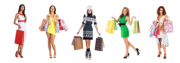 Jovens mulheres bonitas com alguns sacos de compras isolados em branco — Fotografia de Stock