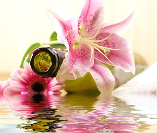 Bottle of massaging oil over spa background — Stock Photo, Image