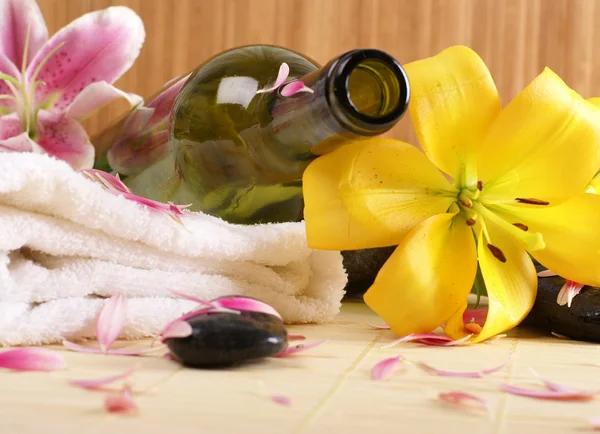 Bottle of massaging oil over spa background — Stock Photo, Image