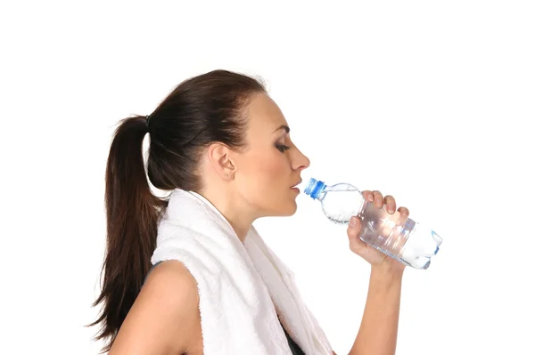 Young attractive female sportsman drinking water — Stock Photo, Image